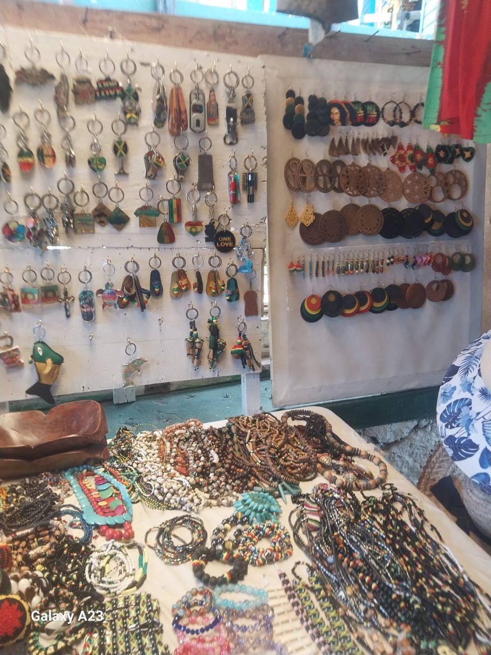 Wall of beaded and wood earrings, keyrings and beaded bracelets and necklaces laid out on a table